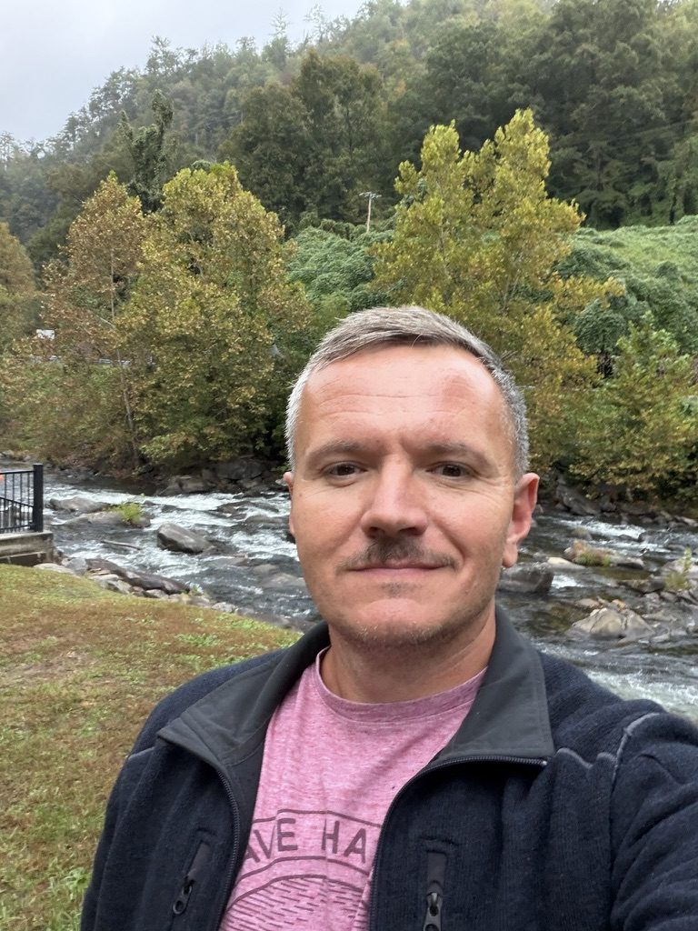 Aaron Kreais beside a river